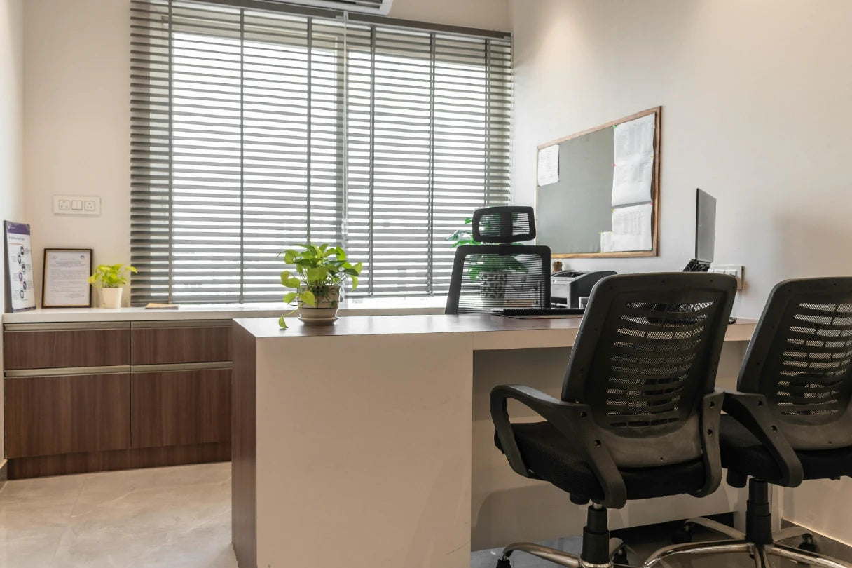 Modern office setup with a desk, chairs, and decor.