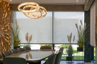 Modern conference room with a large table, chairs, and decorative plants.