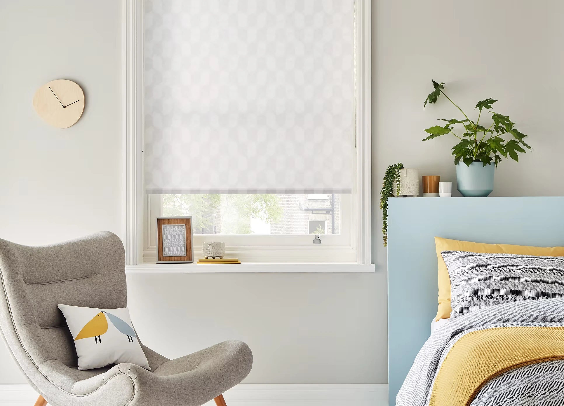 Modern bedroom with a window, chair, and bed with striped bedding.